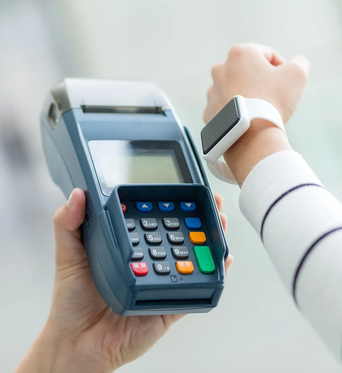 A point of sale terminal accepting payment via an apple watch.